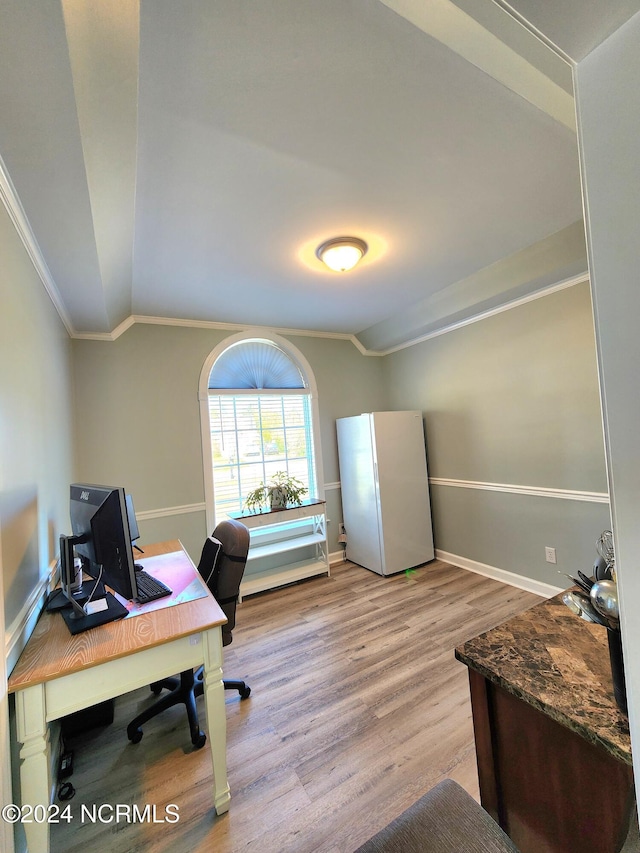 home office featuring vaulted ceiling, crown molding, and light hardwood / wood-style floors