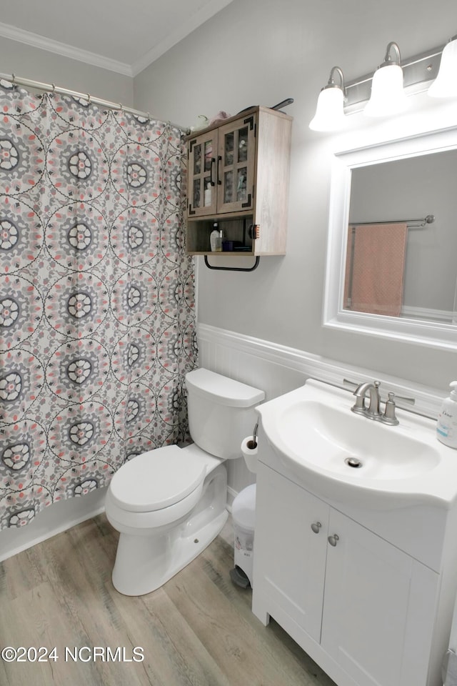 bathroom with toilet, ornamental molding, vanity, a shower with shower curtain, and hardwood / wood-style flooring