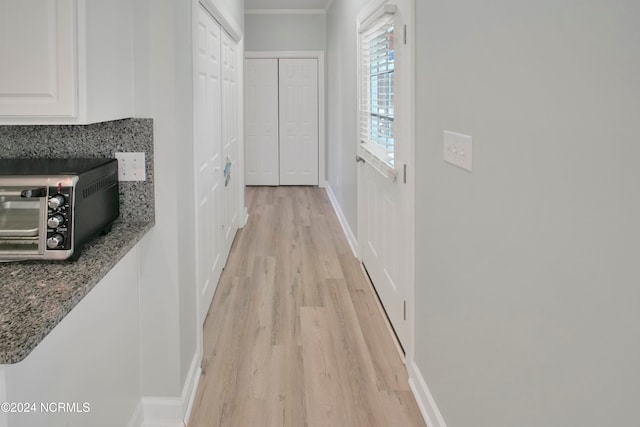 corridor with light wood-type flooring