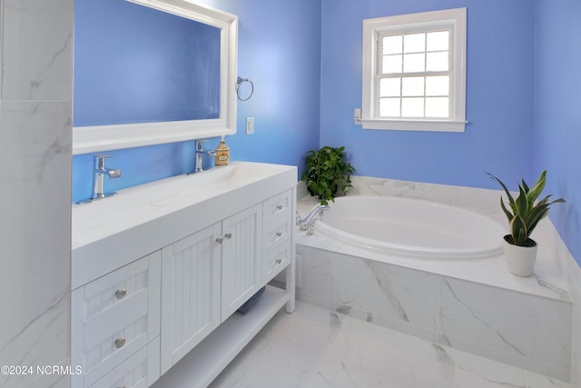 bathroom with vanity and tiled tub