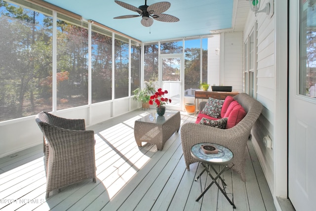 sunroom / solarium featuring ceiling fan