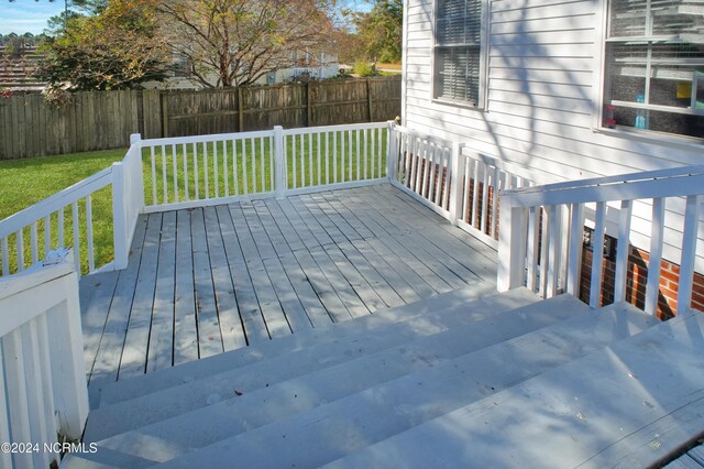 wooden deck with a lawn