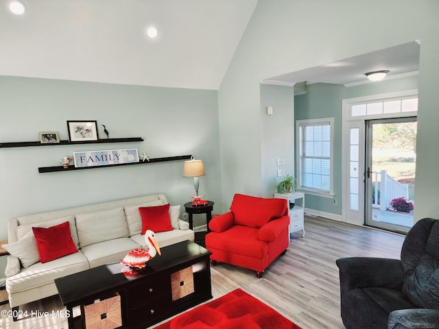 living room featuring vaulted ceiling and light wood-type flooring