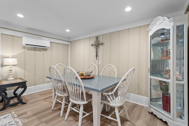 dining room with a wall unit AC, light wood-type flooring, baseboards, and recessed lighting