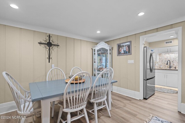 kitchen featuring white cabinetry, stainless steel appliances, sink, and light wood-type flooring