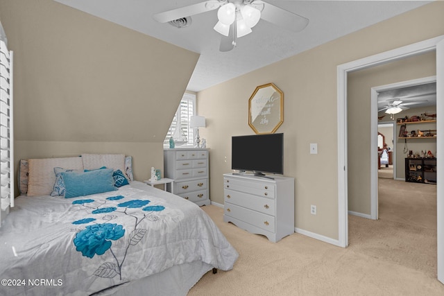 carpeted bedroom featuring vaulted ceiling and ceiling fan