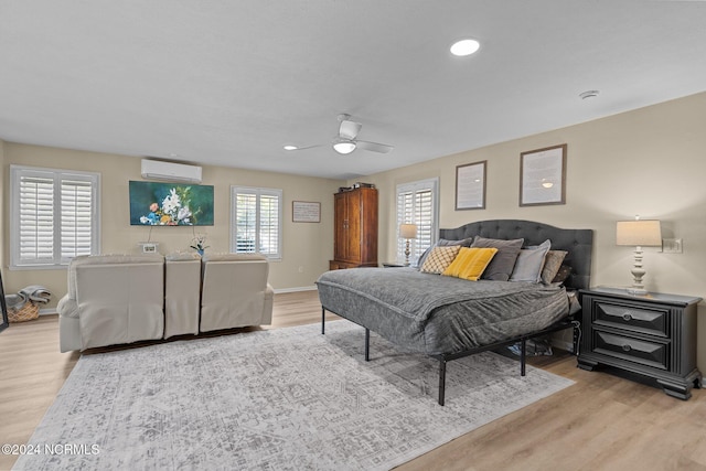 bedroom with baseboards, ceiling fan, a wall mounted air conditioner, light wood-style floors, and recessed lighting