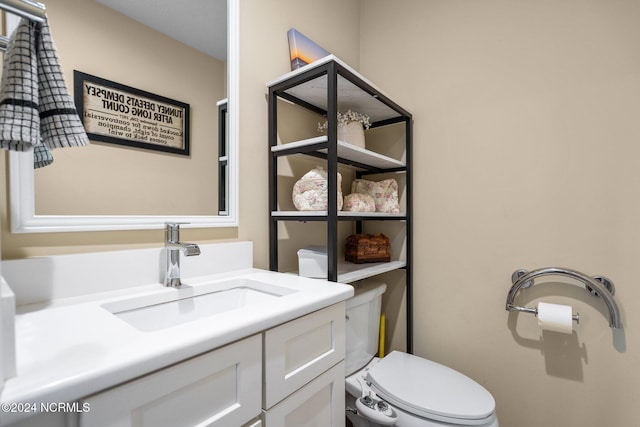 bathroom with toilet and vanity