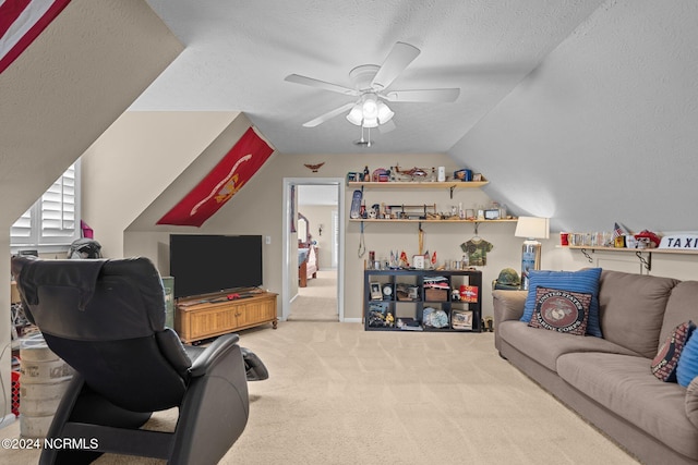 carpeted living room featuring a ceiling fan, vaulted ceiling, and a textured ceiling