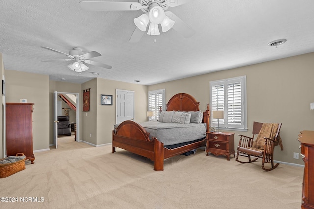 bedroom featuring visible vents, light carpet, and baseboards