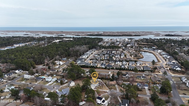 drone / aerial view with a residential view and a water view