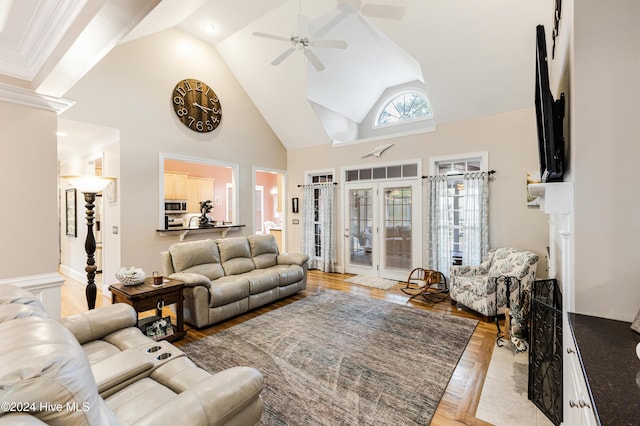 living room featuring ceiling fan, light hardwood / wood-style flooring, and high vaulted ceiling