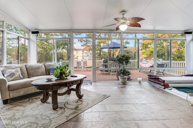 sunroom / solarium featuring ceiling fan and a wealth of natural light