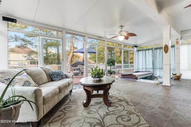 sunroom / solarium featuring vaulted ceiling, a wealth of natural light, and ceiling fan