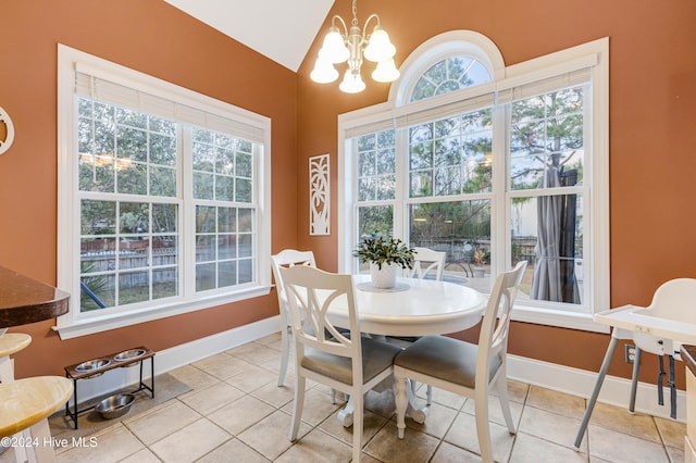 tiled dining area featuring lofted ceiling and a notable chandelier