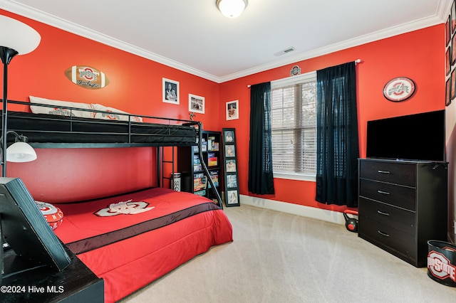 bedroom featuring ornamental molding and carpet floors