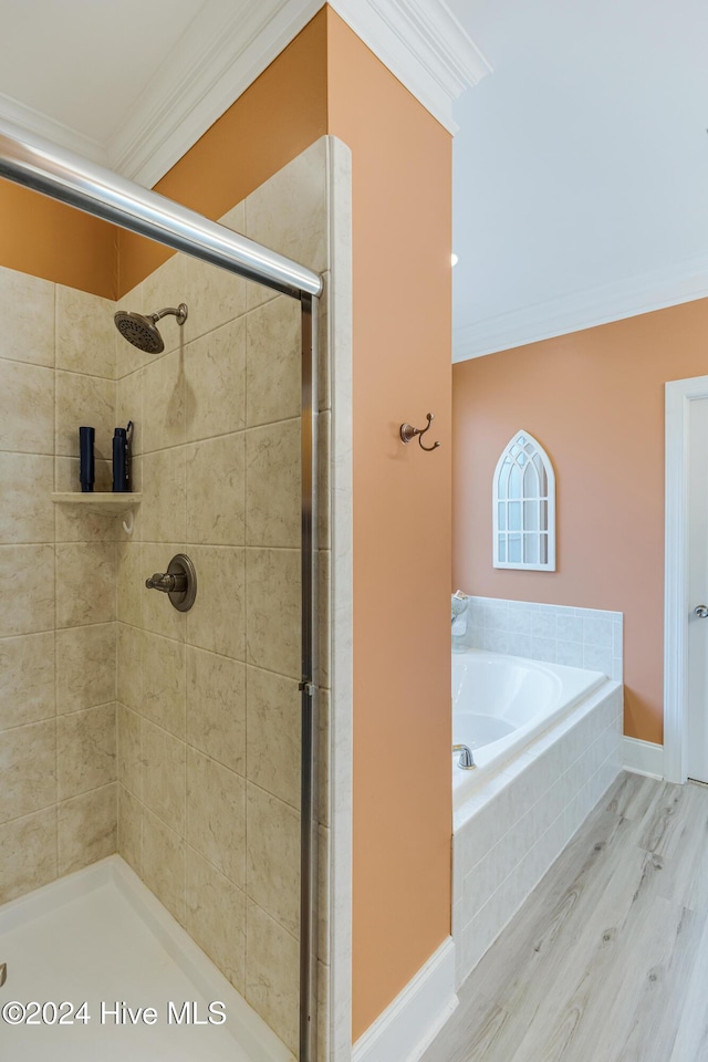 bathroom featuring wood-type flooring, ornamental molding, and plus walk in shower