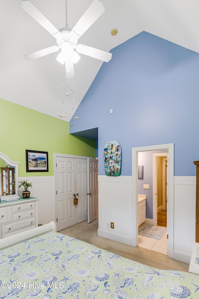 unfurnished bedroom featuring a closet, ensuite bath, ceiling fan, and light colored carpet