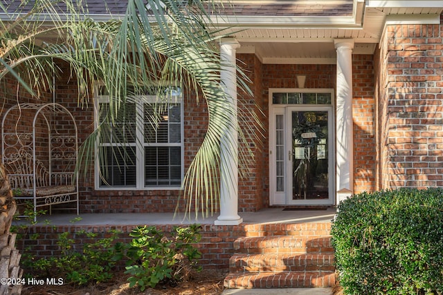 view of exterior entry with covered porch