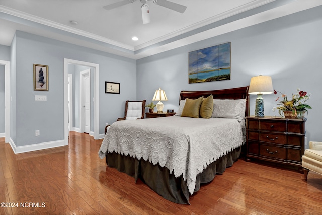 bedroom featuring crown molding, wood-type flooring, and ceiling fan