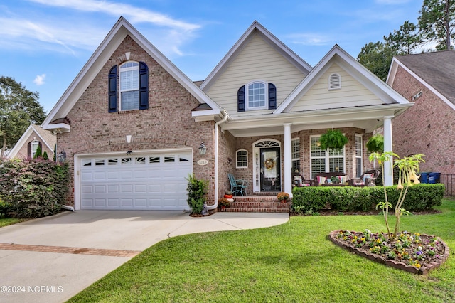 view of front of house with a front yard, a garage, and covered porch