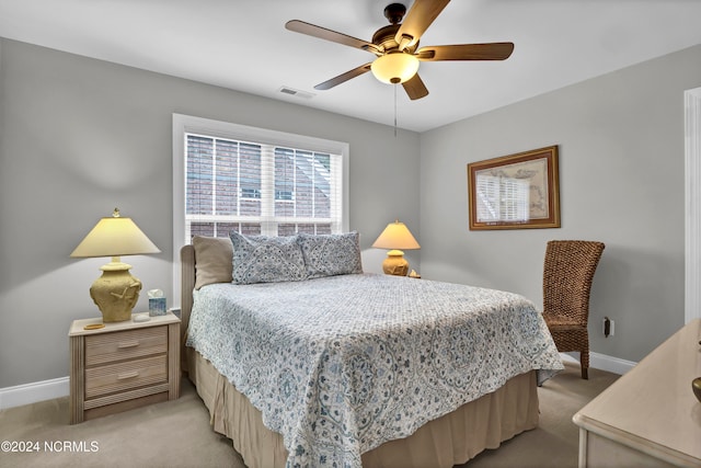 bedroom featuring light colored carpet and ceiling fan