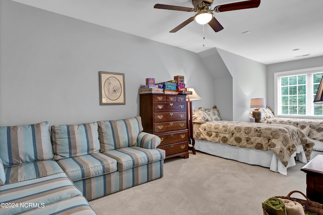 carpeted bedroom with vaulted ceiling and ceiling fan