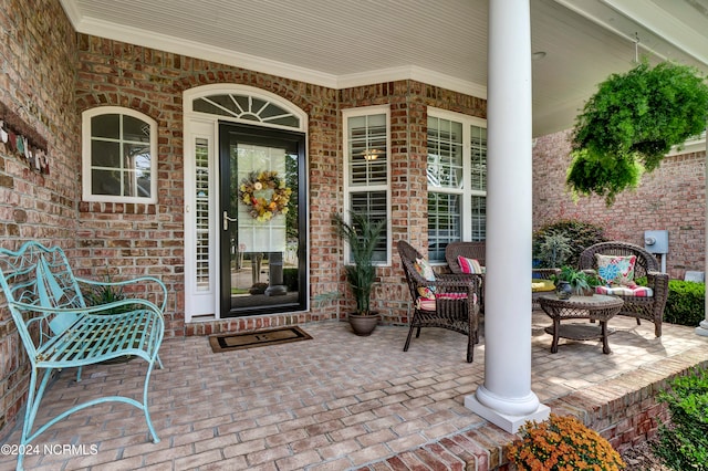 view of exterior entry featuring covered porch