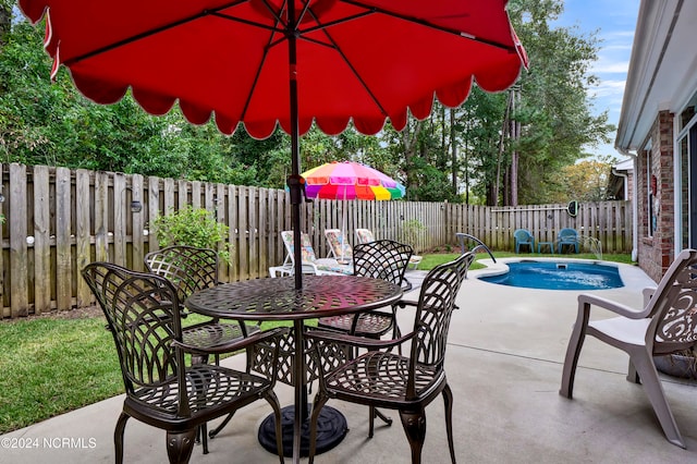 view of patio featuring a fenced in pool