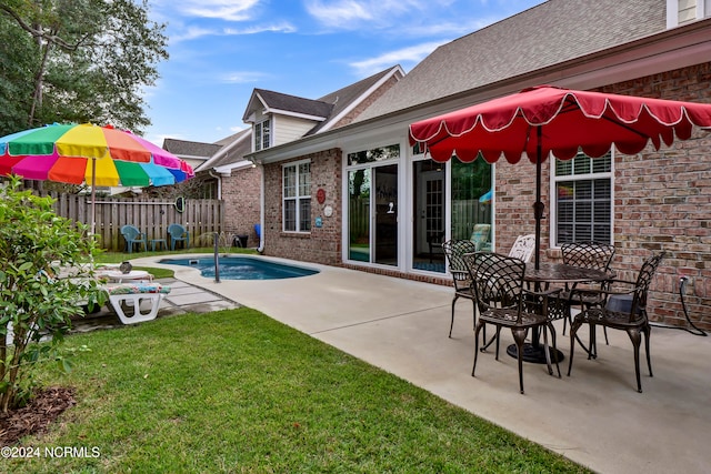 view of swimming pool featuring a patio and a lawn