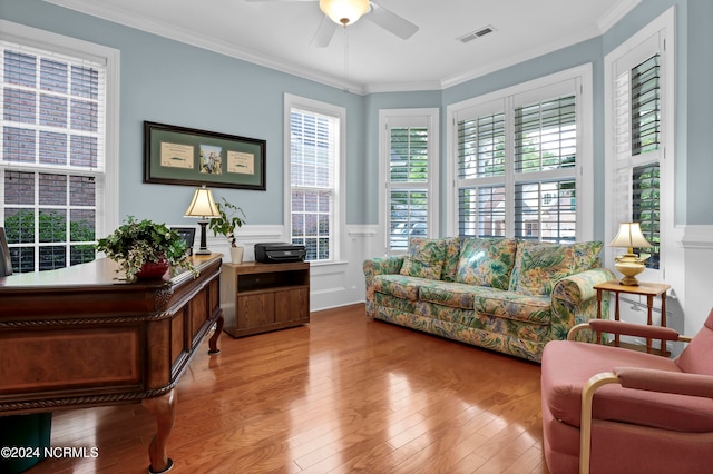 office space with ornamental molding, light wood-type flooring, and ceiling fan