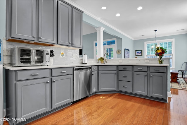 kitchen with stainless steel dishwasher, light hardwood / wood-style flooring, and gray cabinetry