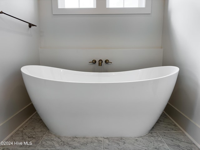 bathroom featuring a healthy amount of sunlight and a bath