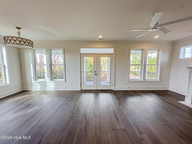 unfurnished living room with crown molding, ceiling fan, french doors, and dark wood-type flooring