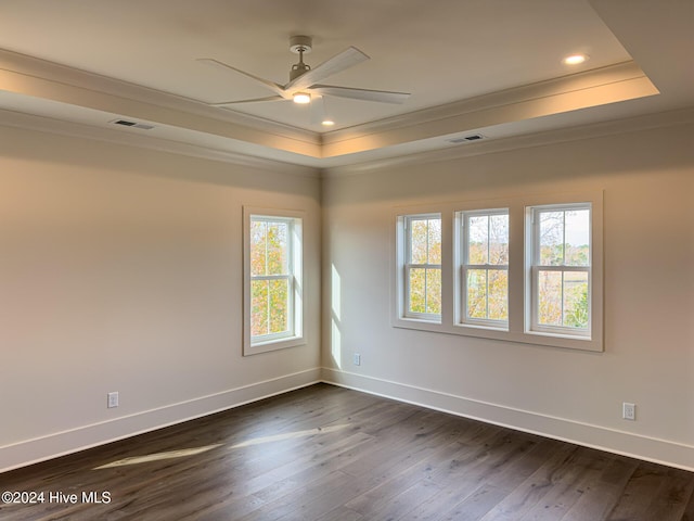 unfurnished room with dark hardwood / wood-style floors, a raised ceiling, ceiling fan, and crown molding