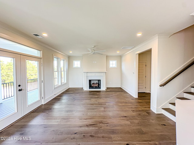 unfurnished living room with french doors, dark hardwood / wood-style floors, ceiling fan, and ornamental molding