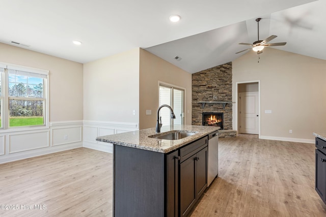 kitchen with stainless steel dishwasher, plenty of natural light, a sink, and visible vents