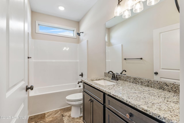 bathroom featuring washtub / shower combination, vanity, and toilet