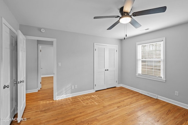 unfurnished bedroom featuring a closet, light wood-type flooring, and ceiling fan