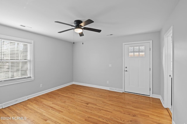 foyer with light hardwood / wood-style floors and ceiling fan