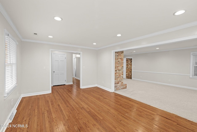 interior space featuring light hardwood / wood-style floors and crown molding