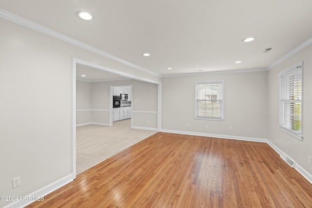 unfurnished room with ornamental molding and light hardwood / wood-style flooring