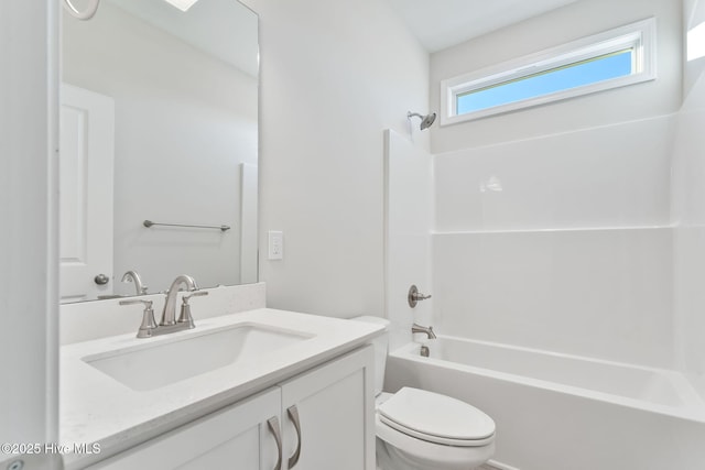 bathroom featuring toilet, bathtub / shower combination, and vanity