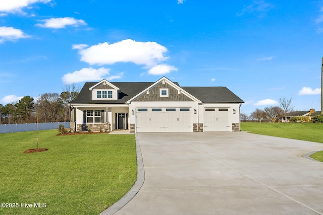 craftsman-style home with an attached garage, fence, concrete driveway, stone siding, and a front yard