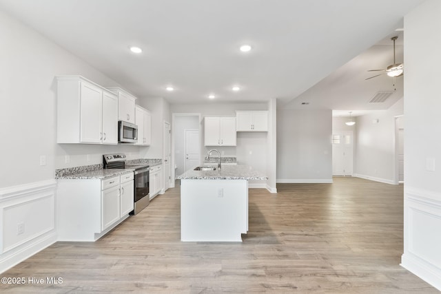 kitchen featuring stainless steel appliances, visible vents, and white cabinetry