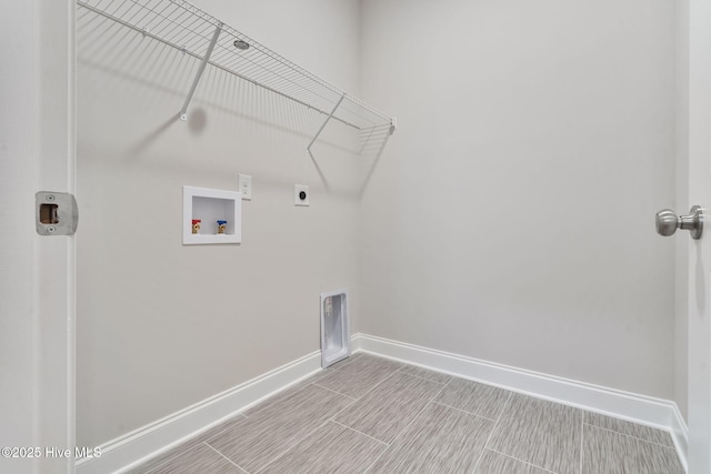 clothes washing area featuring hookup for a washing machine, laundry area, hookup for an electric dryer, and baseboards