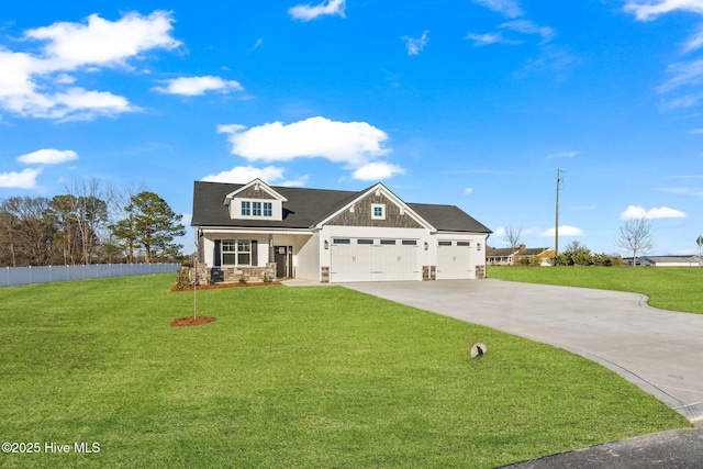 view of front facade featuring a garage, fence, driveway, stone siding, and a front yard