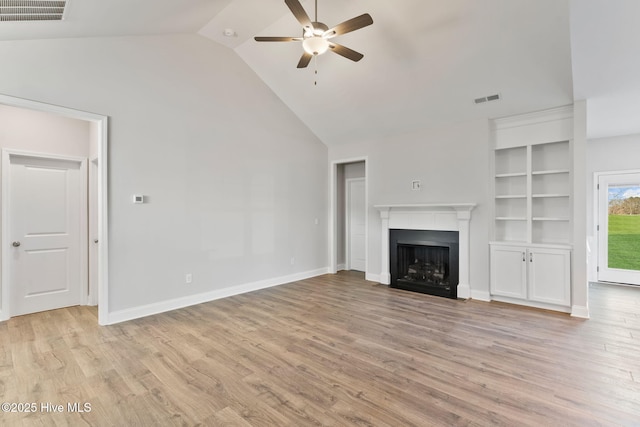 unfurnished living room with light wood finished floors, a fireplace, and visible vents