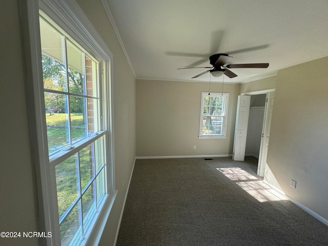 empty room with crown molding, carpet floors, and ceiling fan