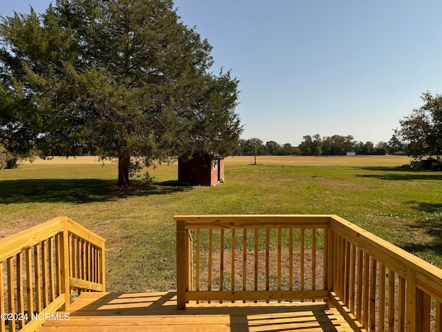 deck featuring a rural view and a lawn